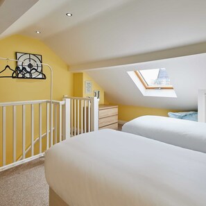 A bedroom with a skylight, a crib, and a dresser. - Host Stay Wild Springs (Wetherby)