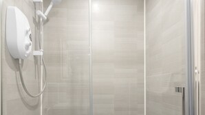 A modern shower with a handheld showerhead and a wall-mounted control panel. - Host Stay Clifton Studio 1 (Darlington)