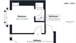 A floor plan of a hotel room layout including a bedroom, bathroom, and hallway. - Host Stay Clifton Studio 1 (Darlington)