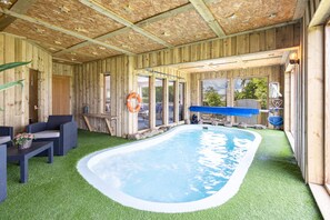 A wooden cabin with a swimming pool, outdoor seating, and a lifebuoy. - Host Stay Crackin View (Hexham)