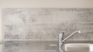 A kitchen with a stainless steel sink, a faucet, and a backsplash. - Host Stay Clifton Studio 4 (Darlington)