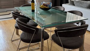 A modern dining area with a glass table, black chairs, and a geometric pendant light. - Spacious 2-bedroom apartment in fabulous Zadar with WiFi, AC, free parking (Zadar)