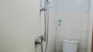 A small bathroom with a toilet, a shower, and a sink. - Hotel O Dealova Room (Gunung Putri)