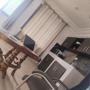 Superior Room | Living area | 43-inch Smart TV with satellite channels, Netflix, toys - Peach City Apartments (Accra)