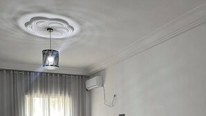 A bedroom with a bed, a nightstand, a lamp, and a ceiling light fixture. - The pearl of the Sousse tourist route 5 minutes from Boujaafer beach (Sousse)