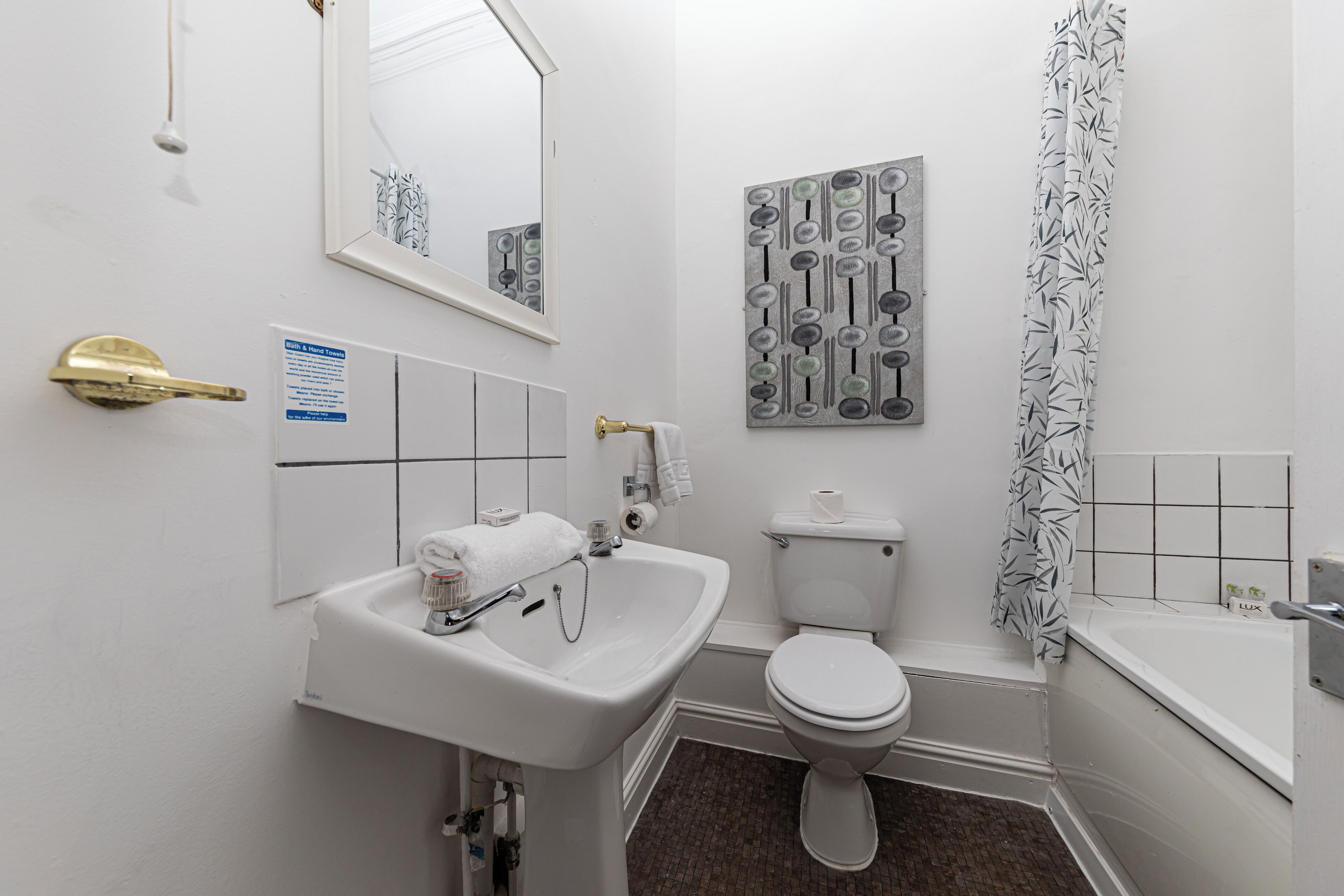 A bathroom with a sink, toilet, and bathtub.