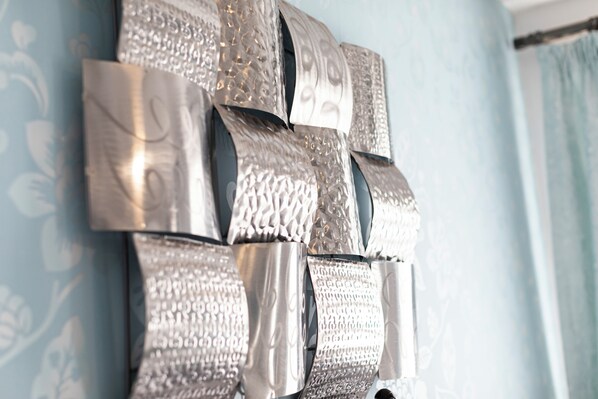 A wall with a textured metallic sculpture. - The Manor Hotel (Llandudno)