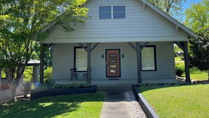 A single-story house with a front porch, a small entryway, and a front door.