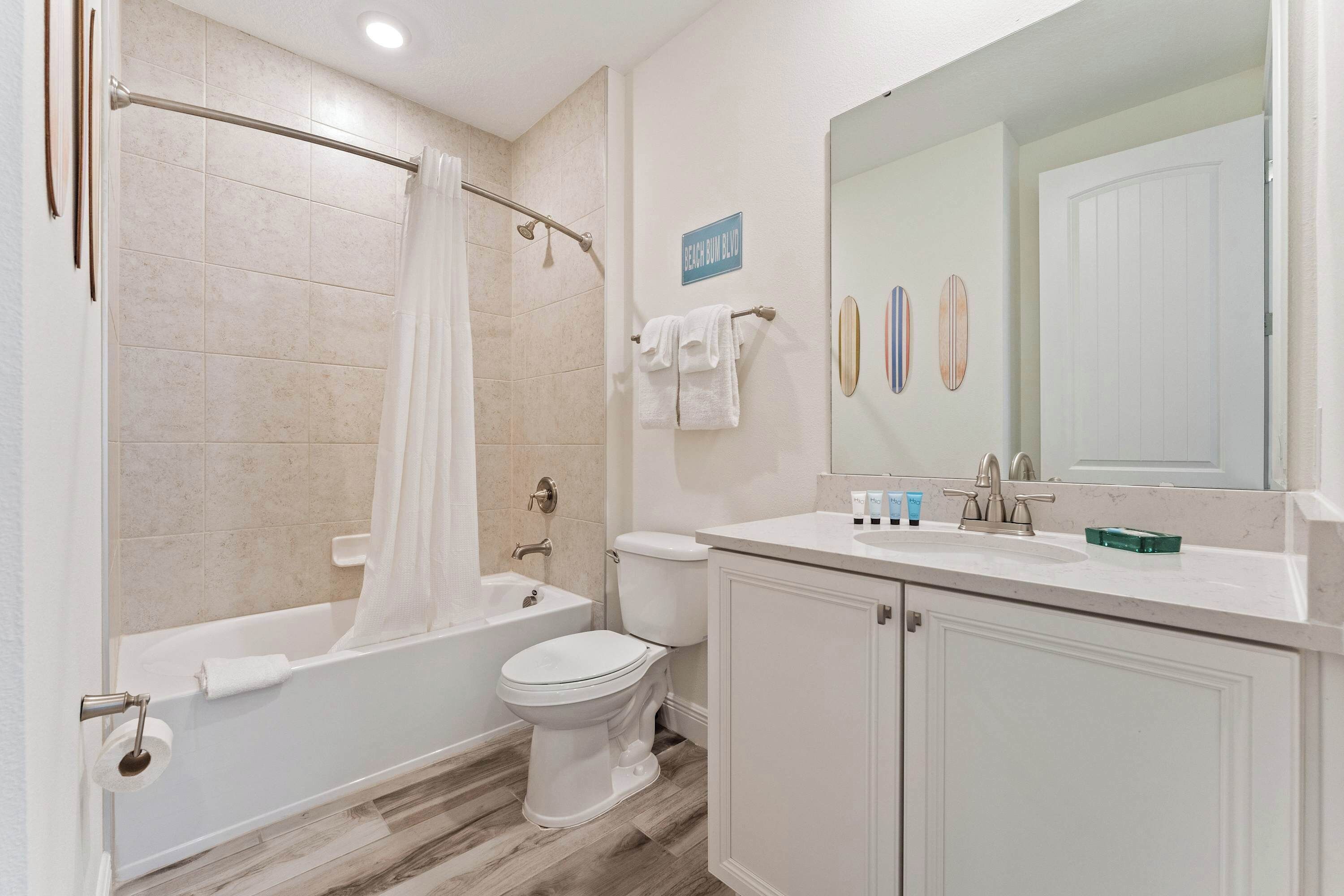A bathroom with a bathtub, toilet, and sink.
