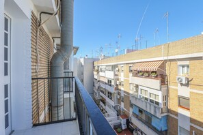 A multi-story residential building with balconies, a visible chimney, and satellite dishes on the roof. - Mirador De Triana in Sevilla (Seville)