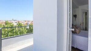 A balcony with a metal railing overlooking a cityscape. - Mirador De Triana in Sevilla (Seville)