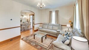 A living room with a sofa, coffee table, and a chandelier. - 5 Mi to Hersheypark: Family Home w/ Game Room (Annville)