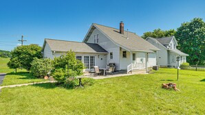 A two-story house with a covered patio, a chimney, and a well-maintained lawn. - 5 Mi to Hersheypark: Family Home w/ Game Room (Annville)