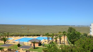 A resort with a large swimming pool, sun loungers, and a view of the beach and ocean. - Las Marismas 71 - Two Bedroom Apartment, Sleeps 5 (Punta del moral)