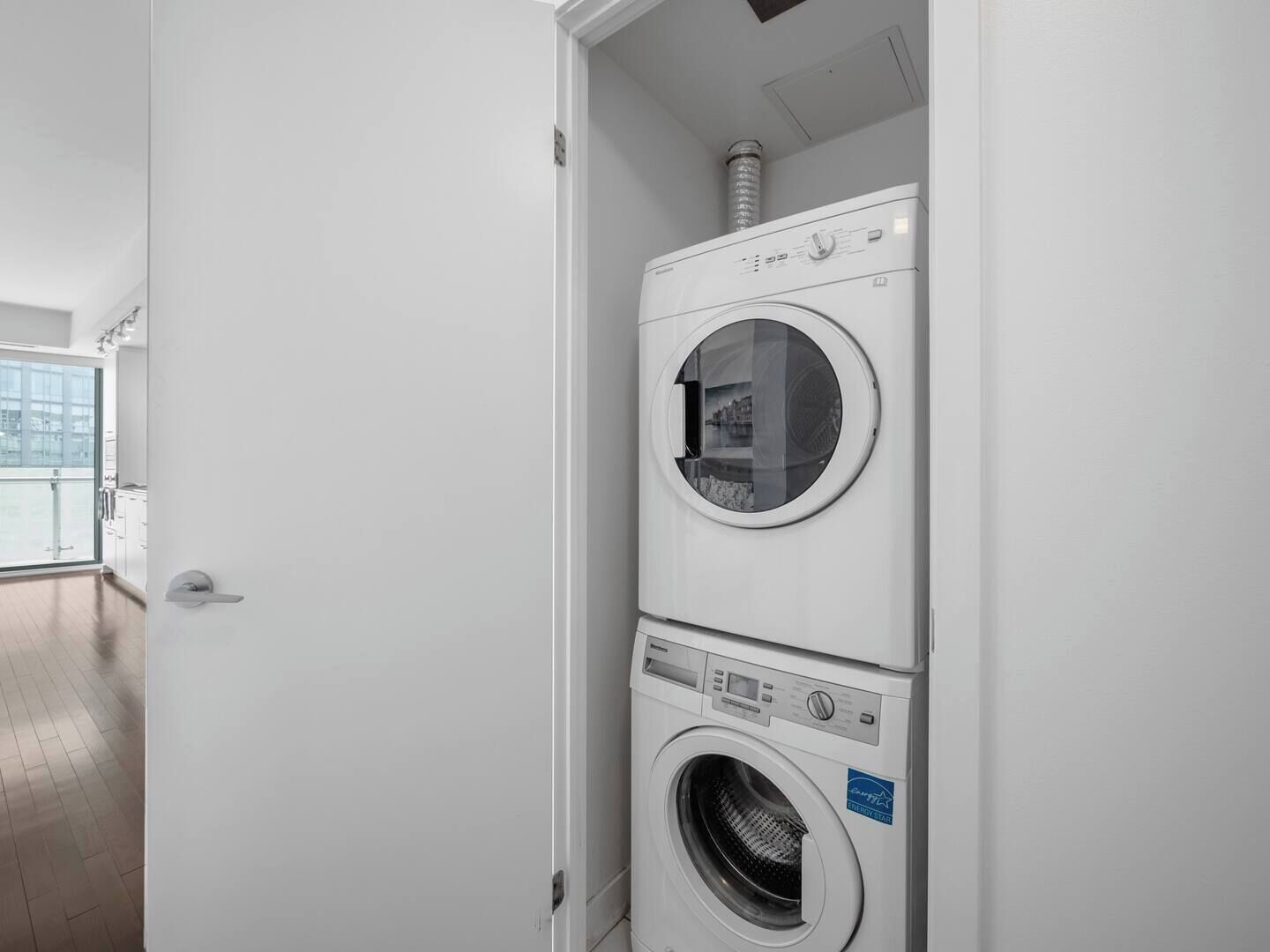 A laundry room with two stacked front-loading washing machines.