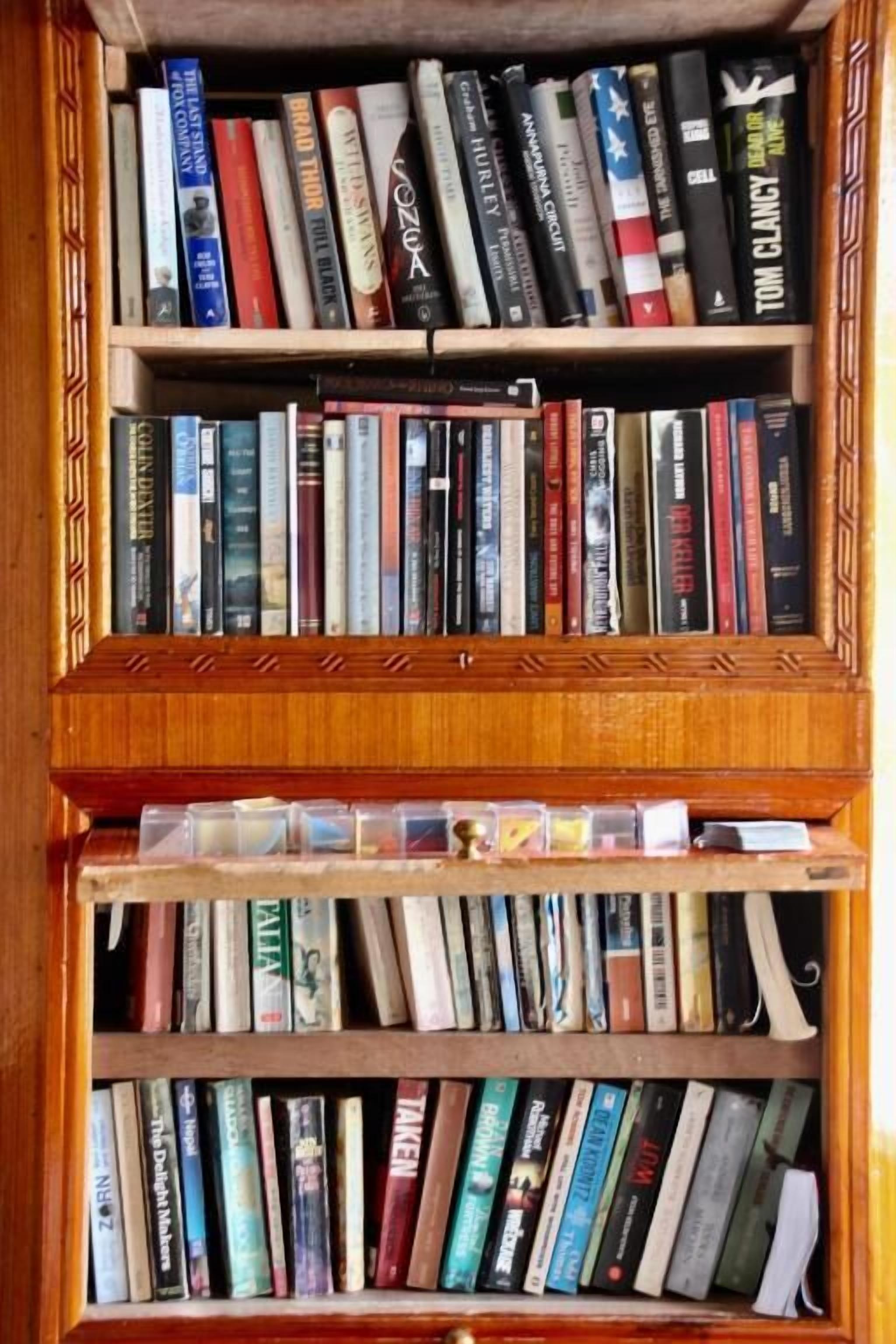A bookshelf with multiple shelves filled with books.