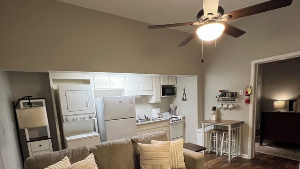 A living room with a sofa, a coffee table, and a patterned rug. - Downtown Starkville Apartment! (Starkville)
