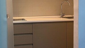 A compact kitchen with a sink, cabinets, and a countertop. - 108 APARTMENT (Turin)