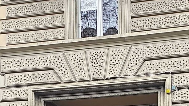 A building entrance with a large wooden door, a sign indicating a sale, and a no parking sign. - 108 APARTMENT (Turin)
