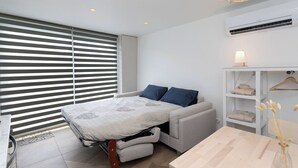 A modern bedroom with a bed, a bedside table, a lamp, and a wardrobe. - Escapade à 2 Bien Être et Déconnexion ! Jacuzzi Privatif (Roumens)