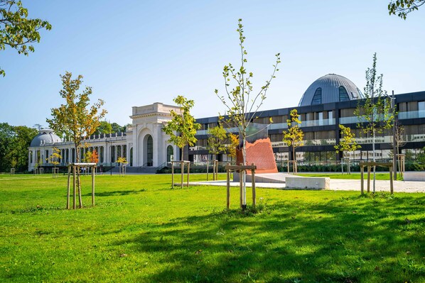 A modern building with a large dome and classical architecture.