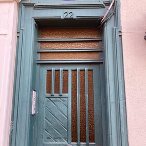 Enter room 22 through this door with a unique textured panel and grid-patterned window.