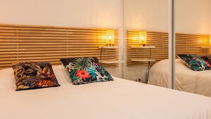 A hotel room with a bed, wooden headboard, and two wall-mounted lamps. - Pretty house with pool in Cagnes-sur-Mer (Cagnes-sur-Mer)