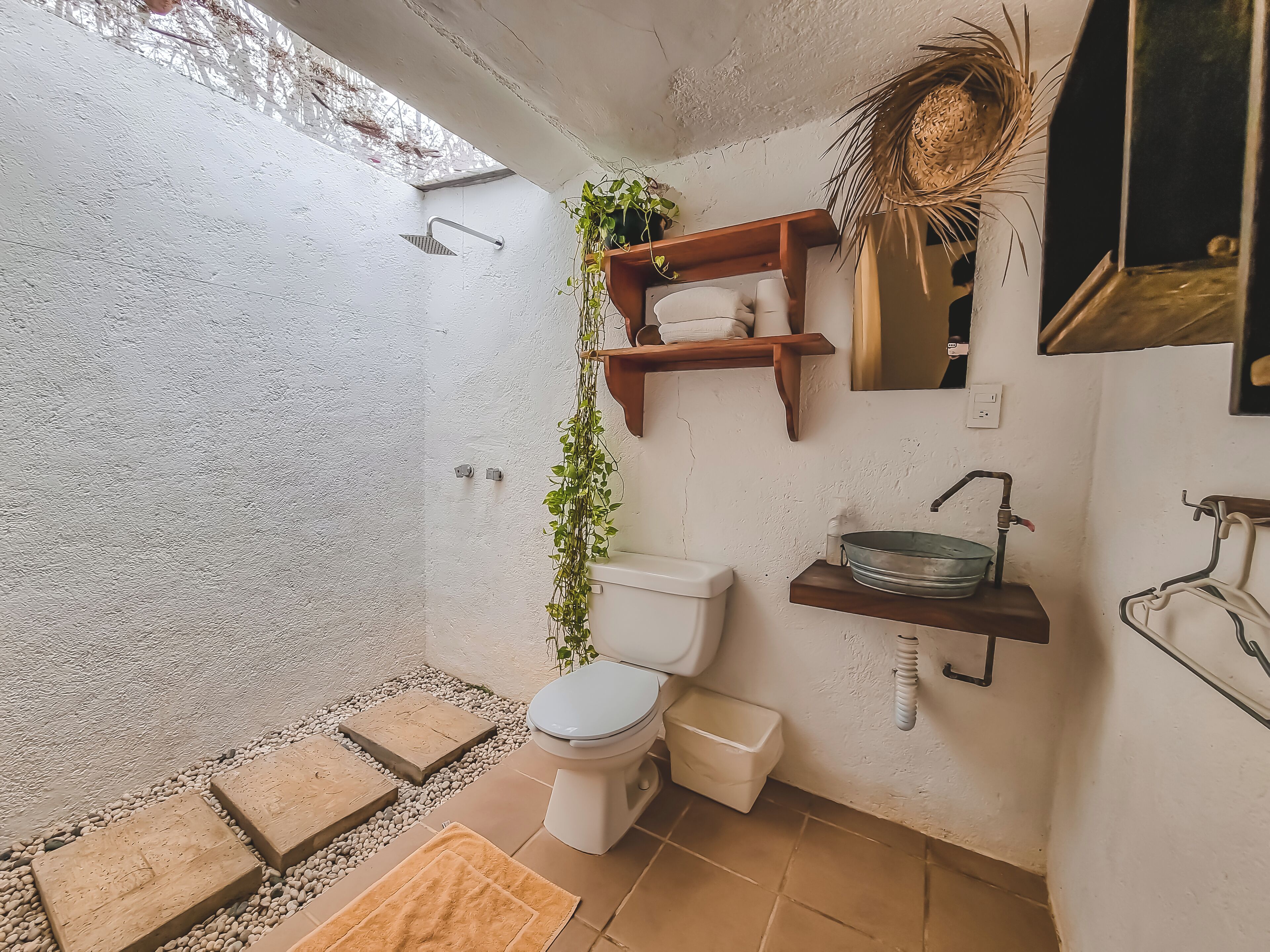 A compact bathroom with a shower, toilet, and sink.