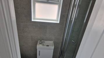 Shower, towels, soap, toilet paper