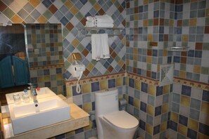 A bathroom with a tiled backsplash, a sink, a toilet, and a towel rack. - Yiyuan Impression Inn (Eryuan)