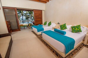 Relax in this stylish room with two single beds, a balcony, and a view of palm trees and the beach.
