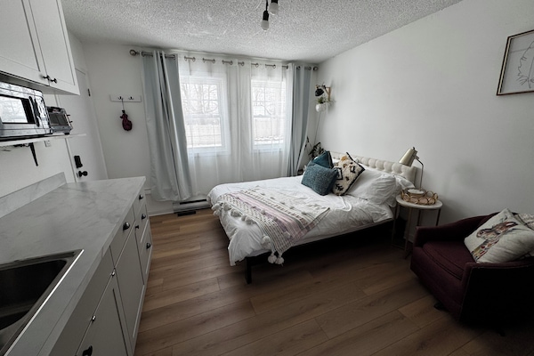 Queen bed, dining area, kitchenette with fridge, cooktop, microwave, toaster.