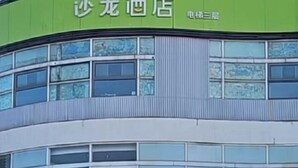 A building with multiple windows and a green sign. - Salon Hotel Beijing Yizhuang Branch (Beijing)