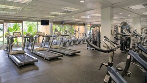 A gym with treadmills, ellipticals, and weight machines.