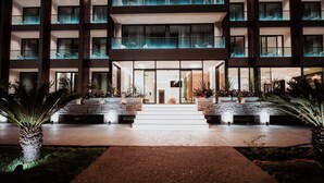 A modern hotel with a central courtyard, multiple balconies, and a well-lit entrance. - Euro Hotel (Ksamil)