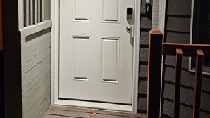 A white door with a 'B' marking, a keypad lock, and a small window. - Marine View Townhouse (Everett)
