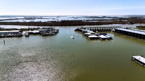 A marina with boats docked and a large building with a flat roof.