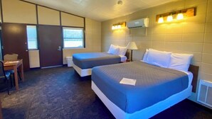 A hotel room with two beds, a desk, and a chair. - Thousand Hills (Kirksville)
