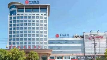 A multi-story hotel with a modern design, featuring a prominent signage at the top.