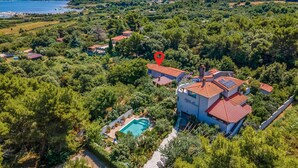 An aerial view of a property with a swimming pool, surrounded by dense greenery and a red-roofed building. - Stunning home in Liznjan with private swimming pool, can be inside or outside (Liznjan)