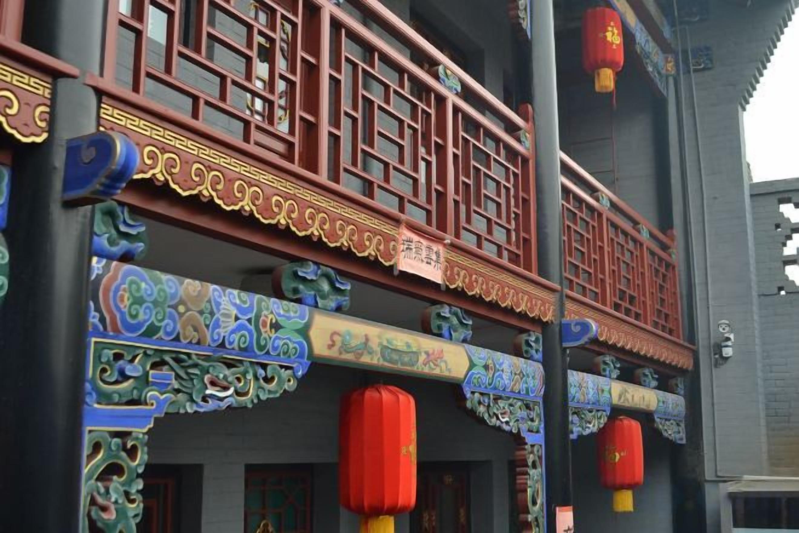 A traditional building with ornate architectural details, including colorful decorations and red lanterns.