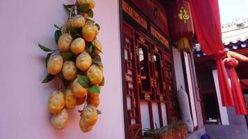 A building with a wall-mounted fruit display and traditional architectural elements.