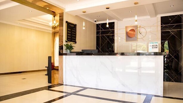 A hotel reception area with a marble reception desk, a black and white checkered floor, and a modern chandelier. - Sanmen Longyoujia Boutique Hotel (Sanmen)