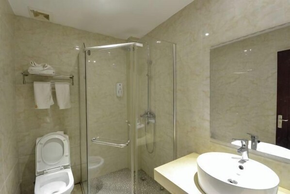 A modern bathroom with a glass-enclosed shower, a toilet, and a vanity with a sink. - Sanmen Longyoujia Boutique Hotel (Sanmen)