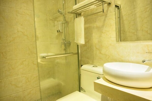 A bathroom with a glass shower enclosure, a white sink, and a towel rack. - Sanmen Longyoujia Boutique Hotel (Sanmen)