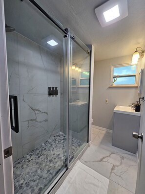 Shower, hair dryer, towels, soap