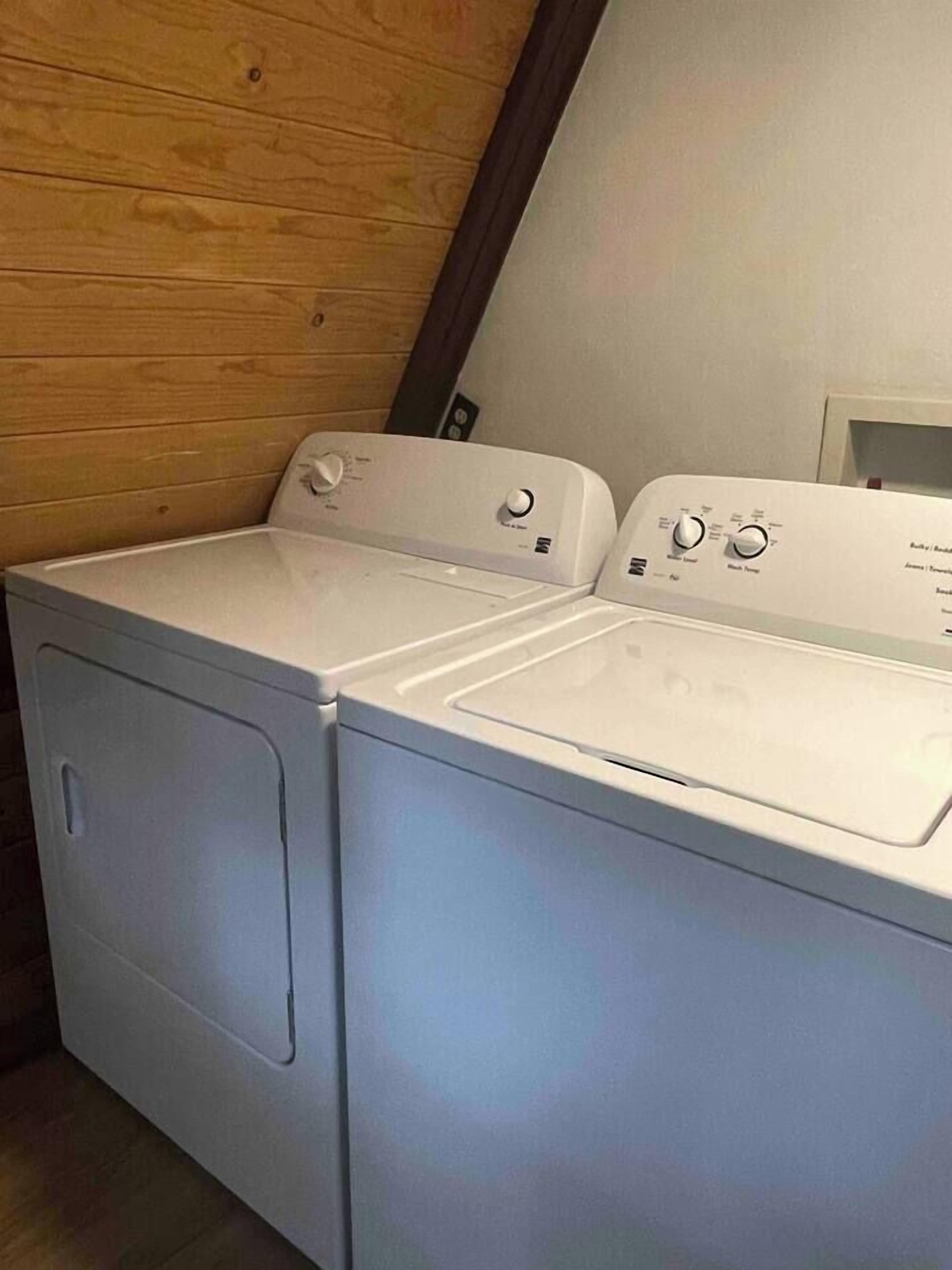 A laundry area with two stacked front-loading washing machines.