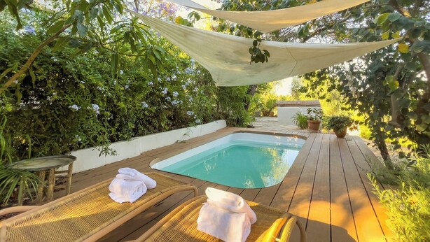A wooden deck with a hot tub, surrounded by lush greenery and a hammock. - Flor de Pita Jimena de la Frontera by Ruralidays (Cádiz)