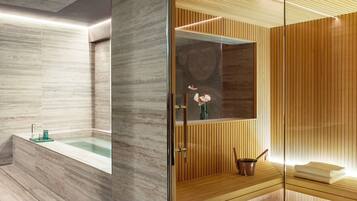 Un bagno moderno con una vasca da bagno in marmo, un mobile vanitario in legno e un box doccia in vetro.