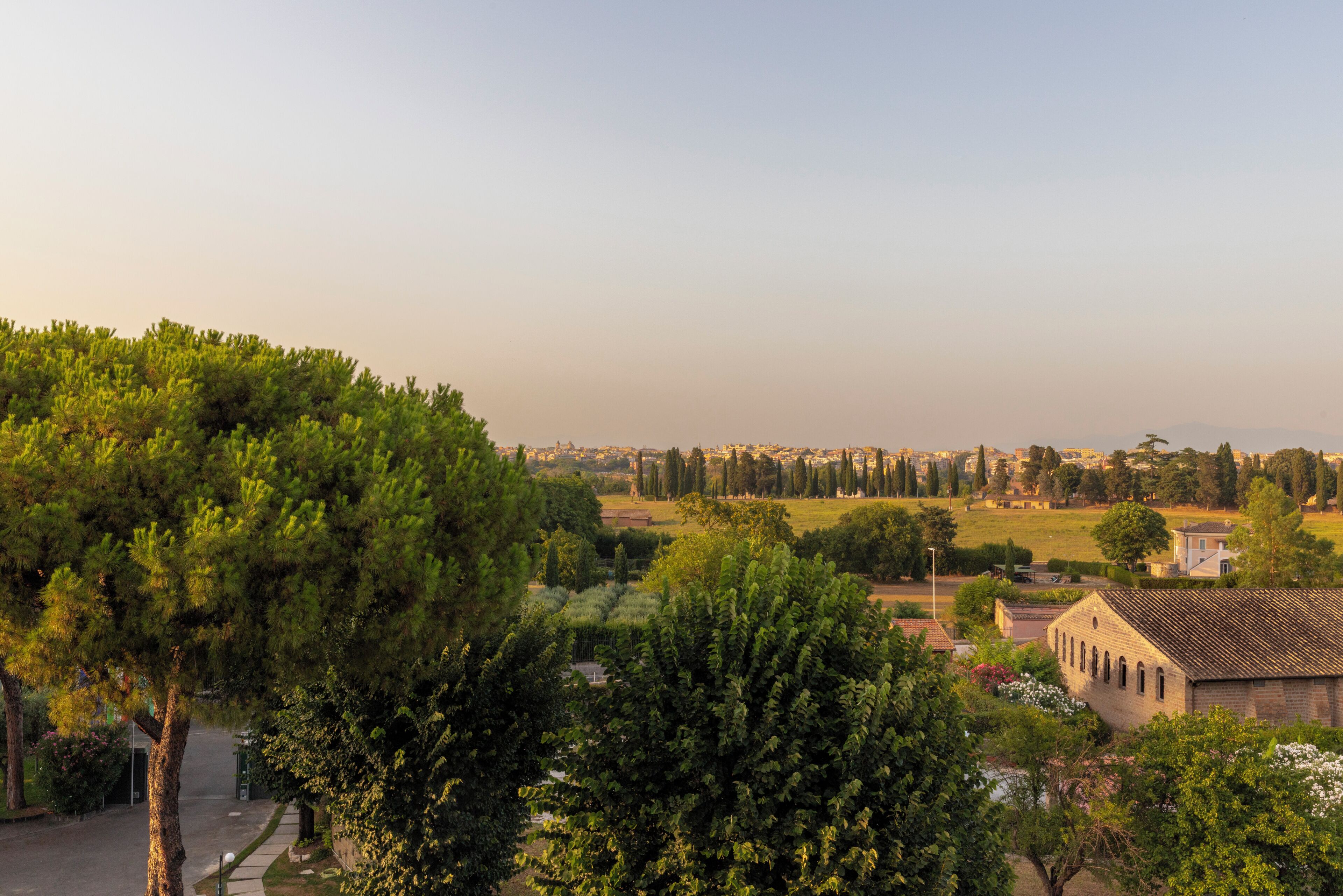 A view of a town with buildings, trees, and a clear sky.